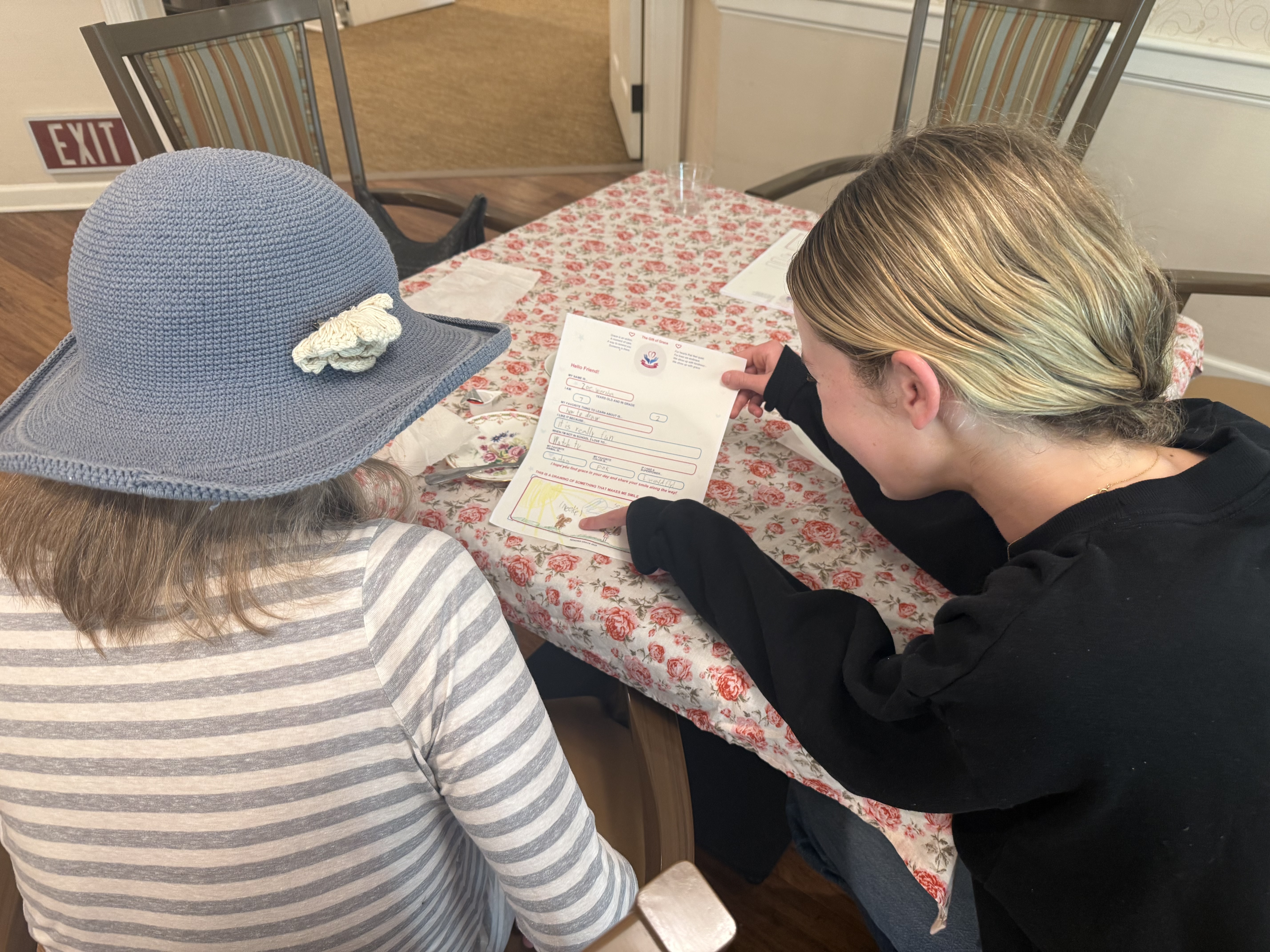 Grace reading a letter with a resident