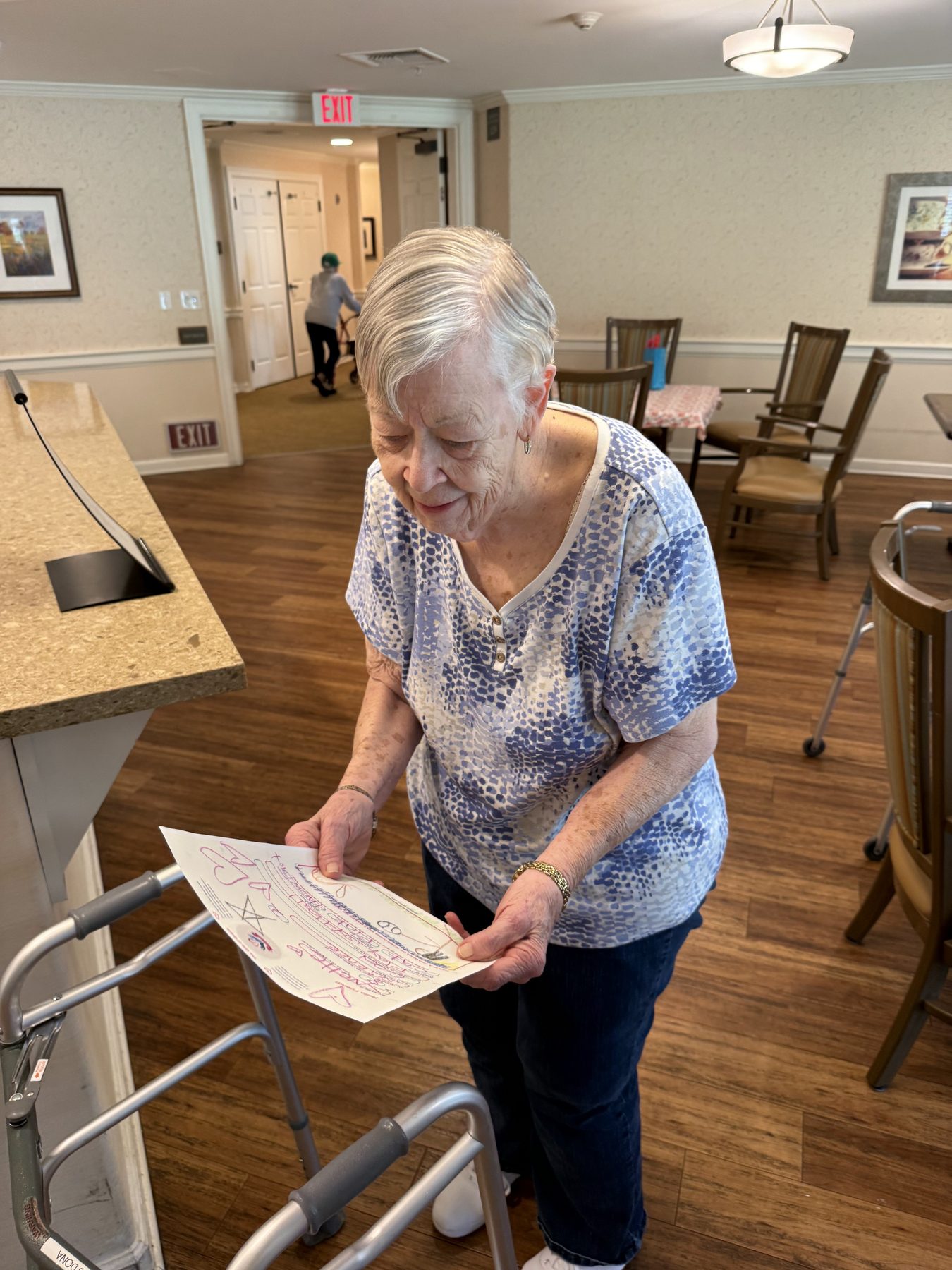A resident smiling as she reads her letter