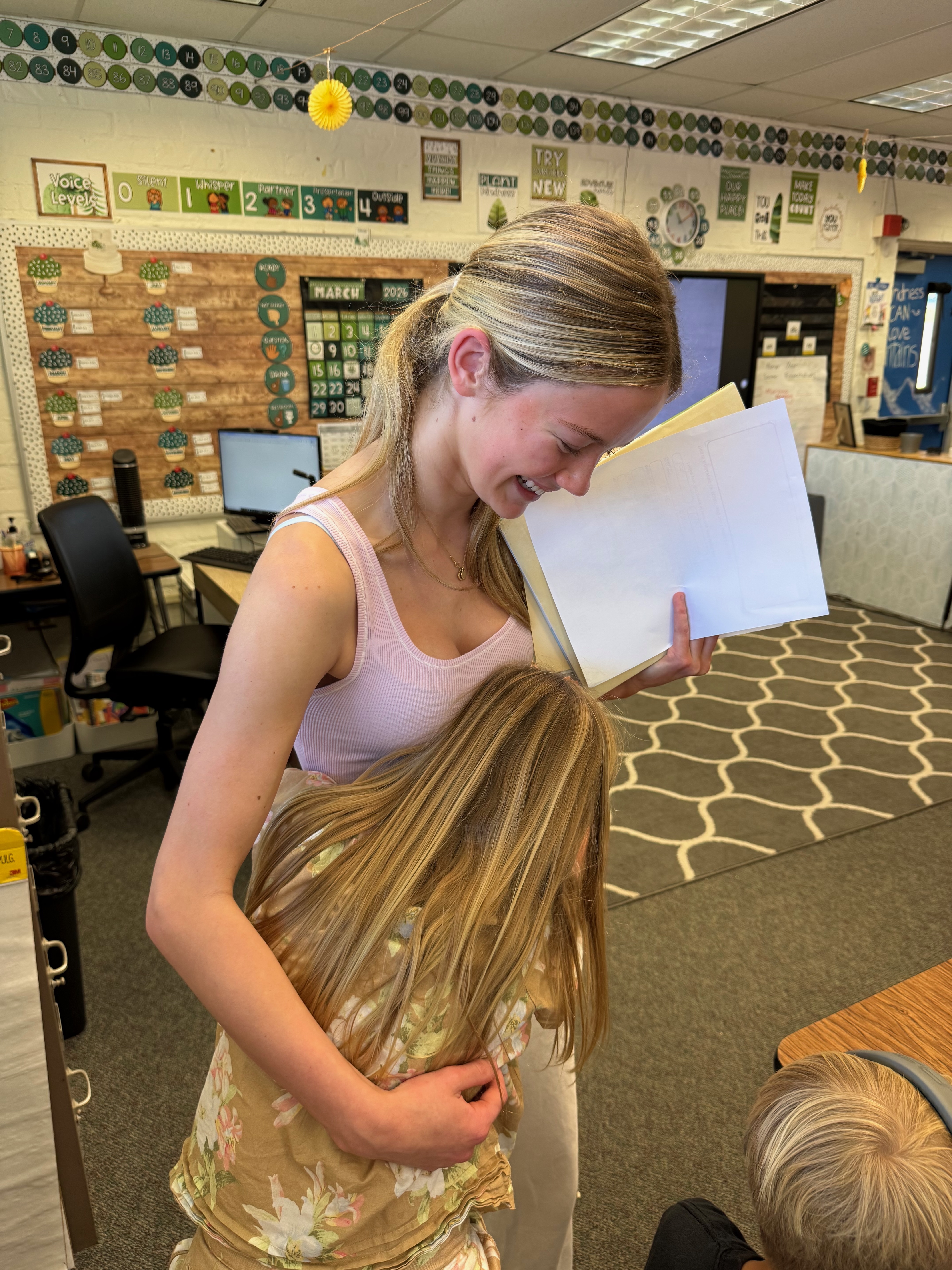A student hugging Grace after a Sending Grace letter-writing session