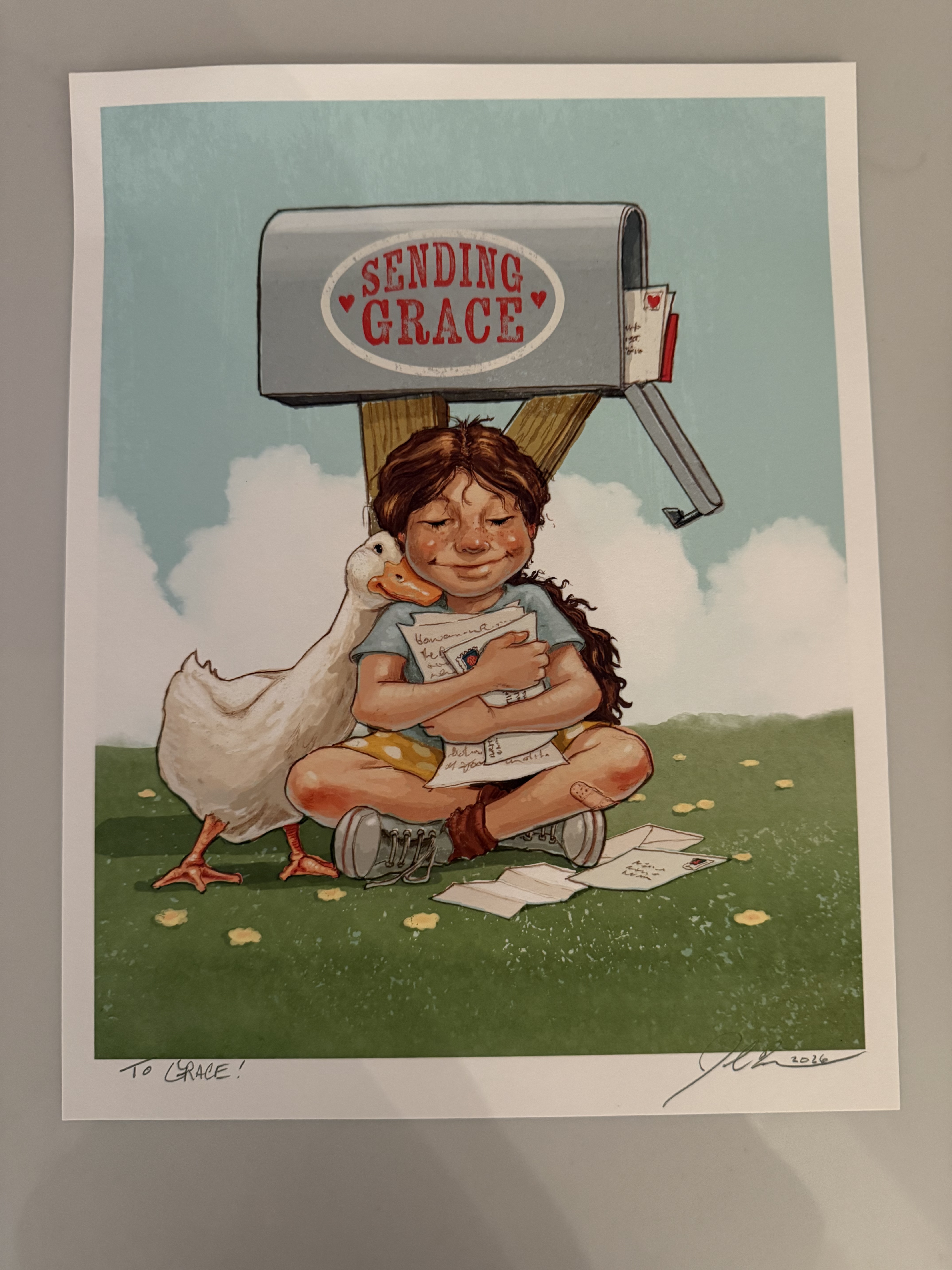 Original artwork by John Rocco depicting a girl sitting under a Sending Grace mailbox, hugging a goose and holding letters