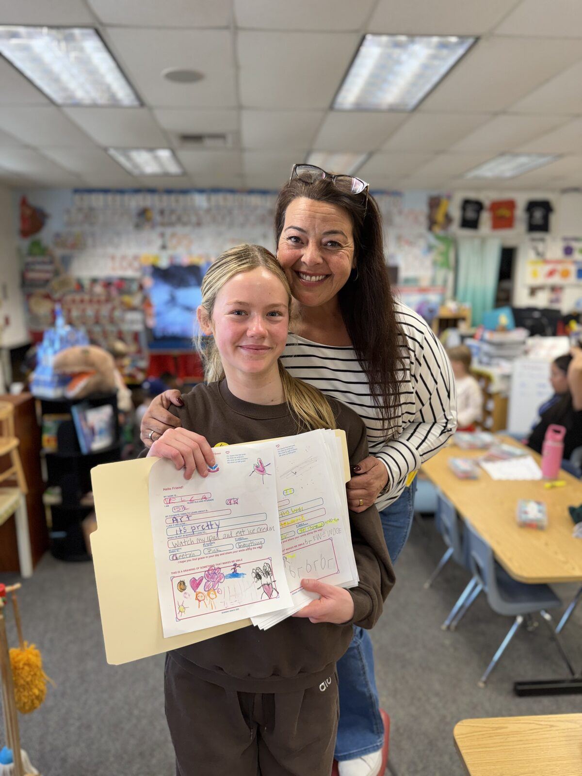 Grace with Ms. Schmitz holding completed letters