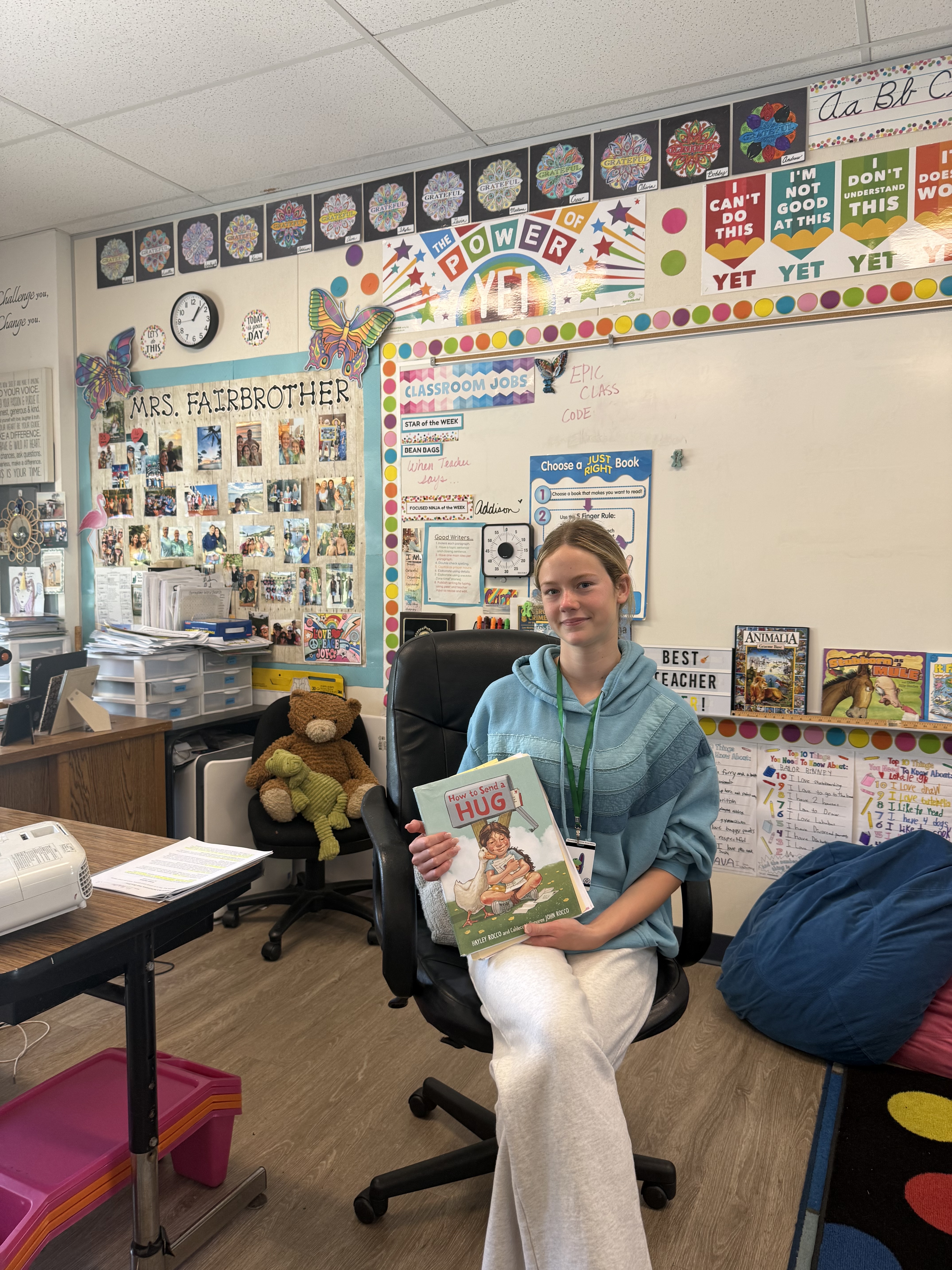Grace holding How to Send a Hug in Mrs. Fairbrother's classroom at Grand View Elementary