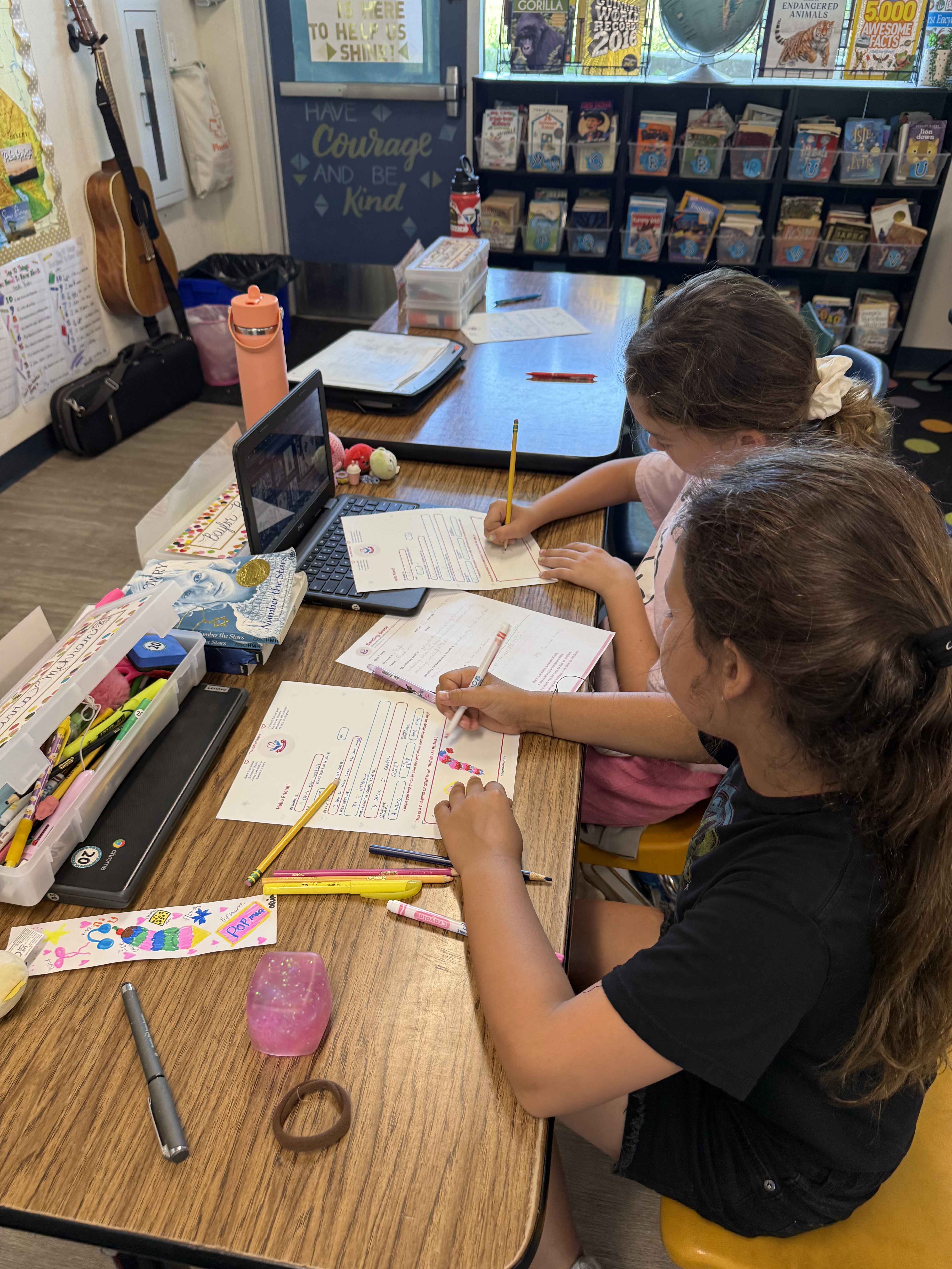 A student drawing his friends on his Sending Grace letter