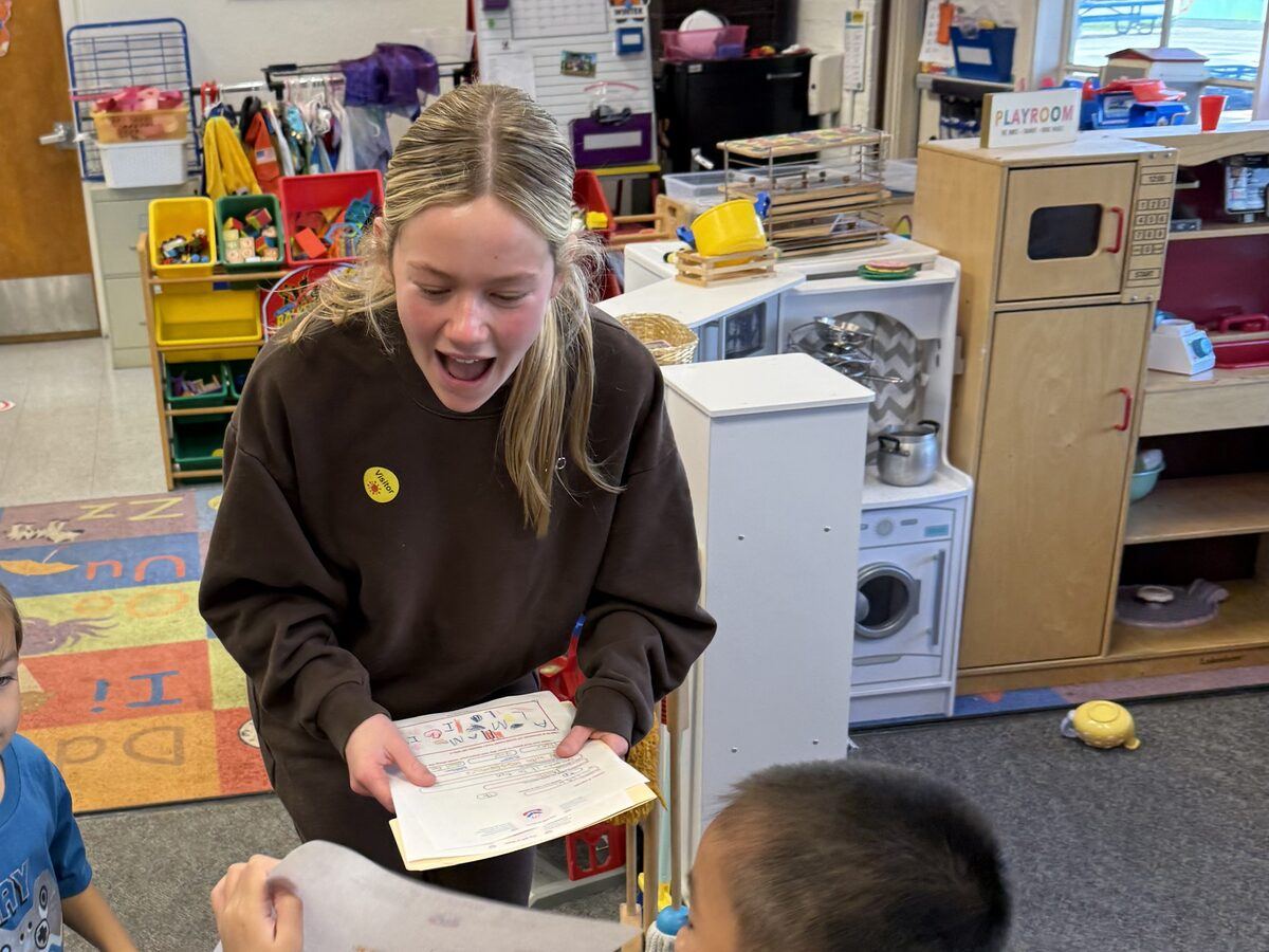 Grace collecting finished letters from students