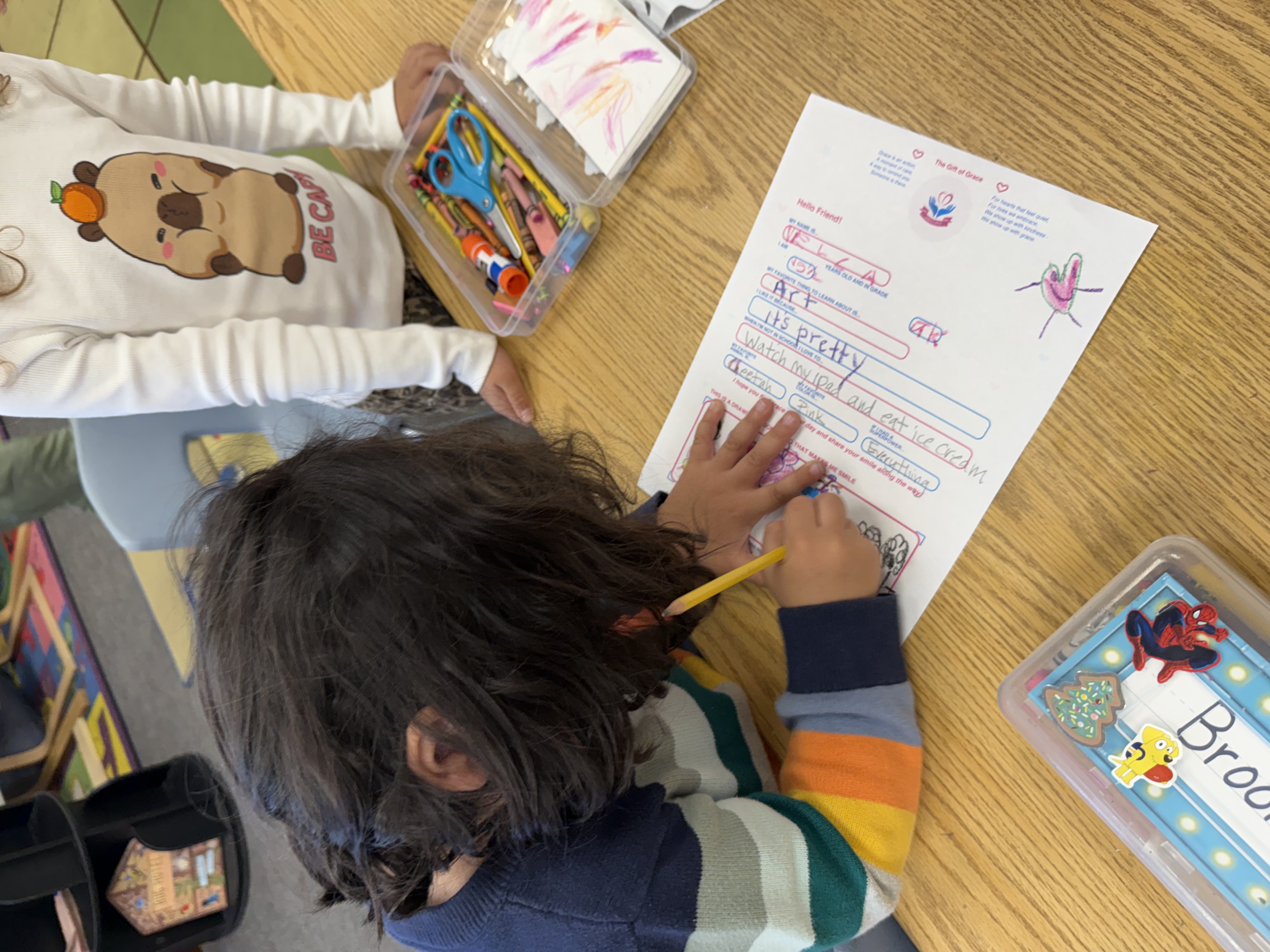 Grace helping a student with their letter