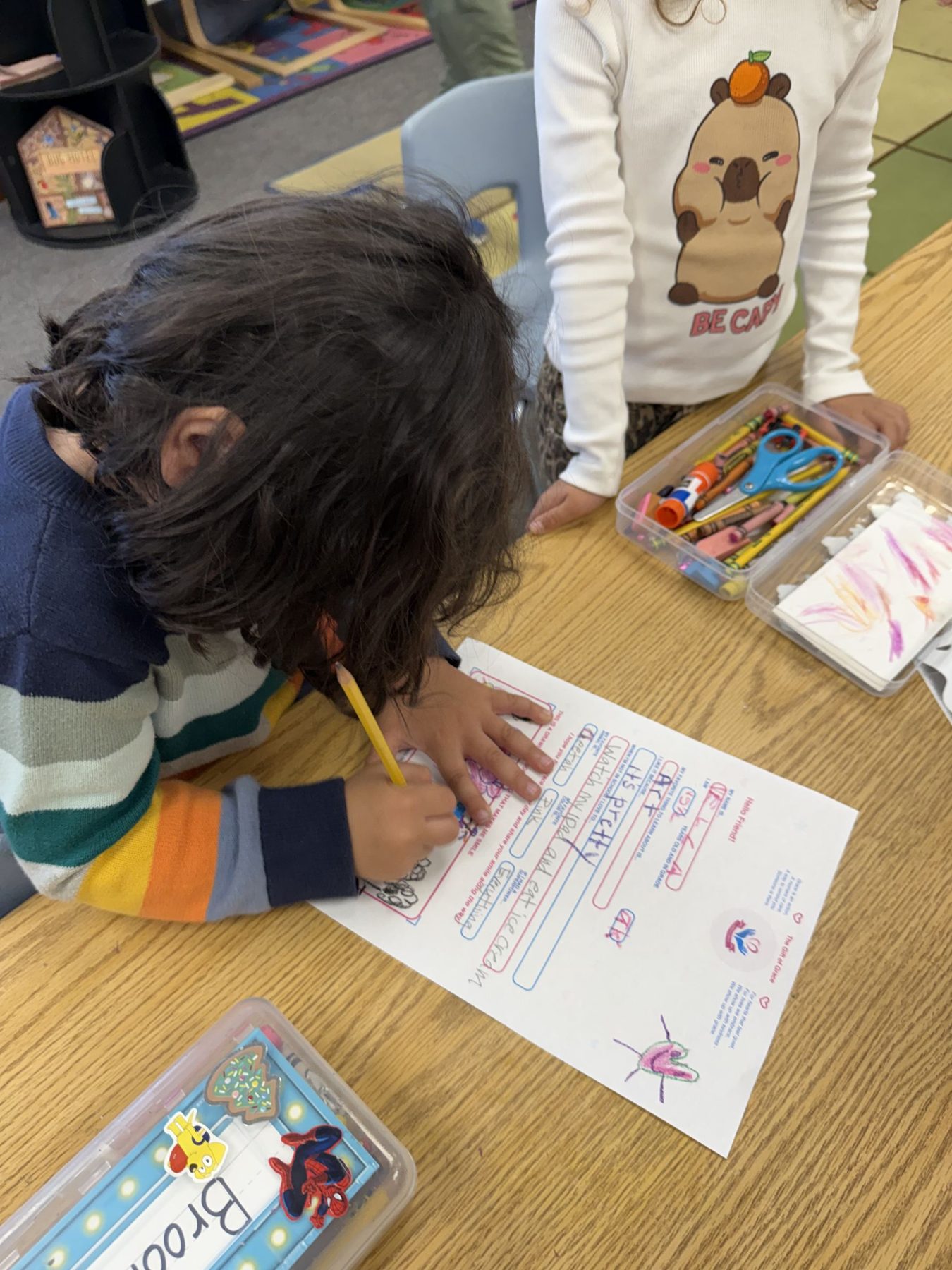 A student writing a Sending Grace letter at a classroom table